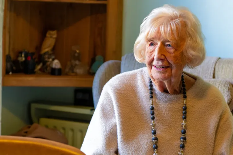 Client receiving round-the-clock care at home with a dedicated Carer nearby.
