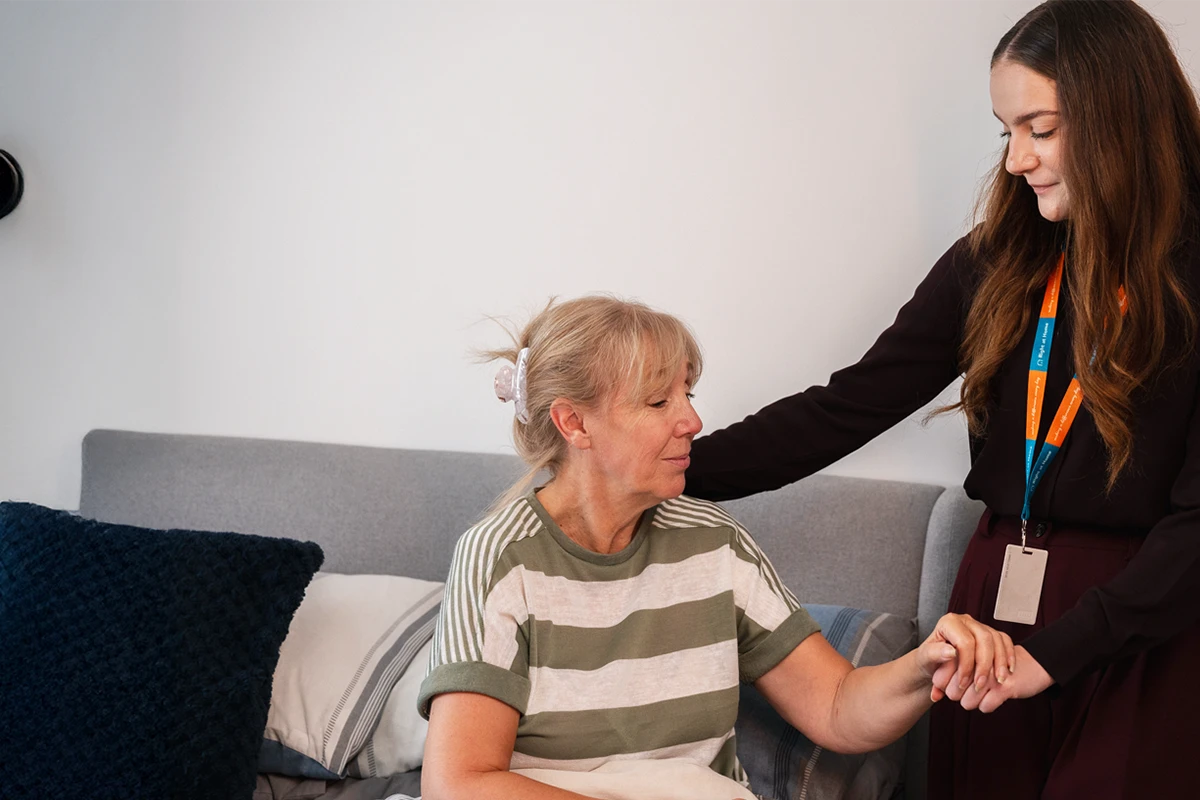 Care Assistant supporting Client living with neuromuscular disorder to get ready for the day