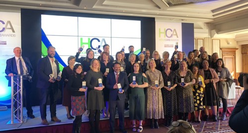 Home care awards Right at Home CEO stands to celebrate with other winners from social care